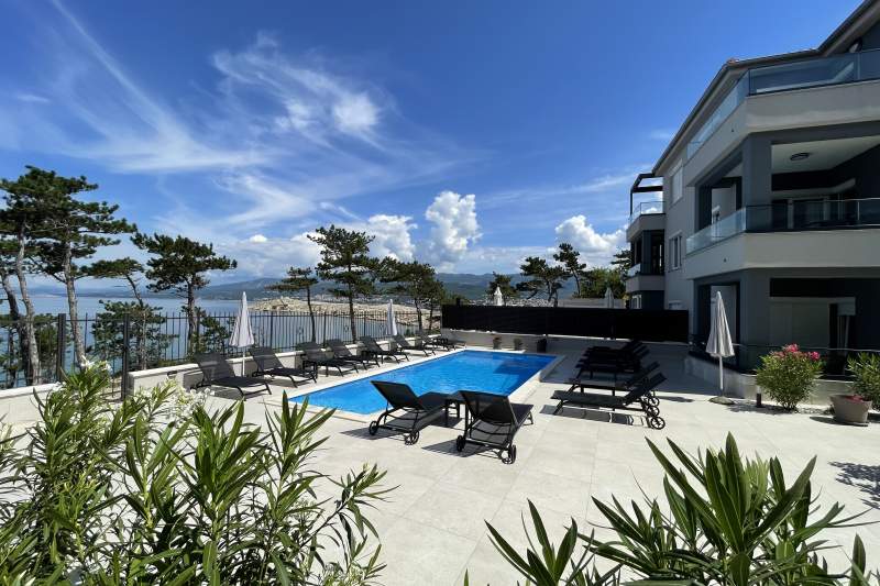 How can I book a villa or apartment on your website and what are the payment options?